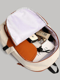 Open beige backpack with brown accents containing books and stationery on a gray background