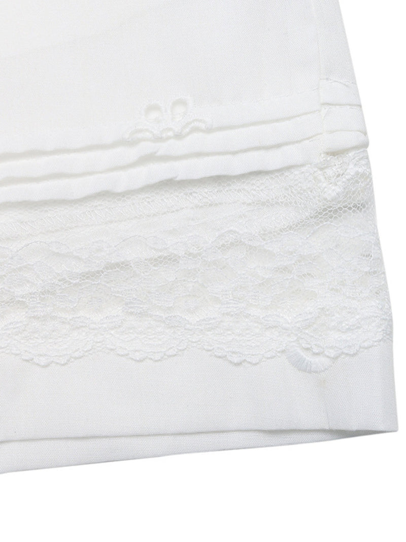 Close-up of a white textured fabric with lace trim on a white background