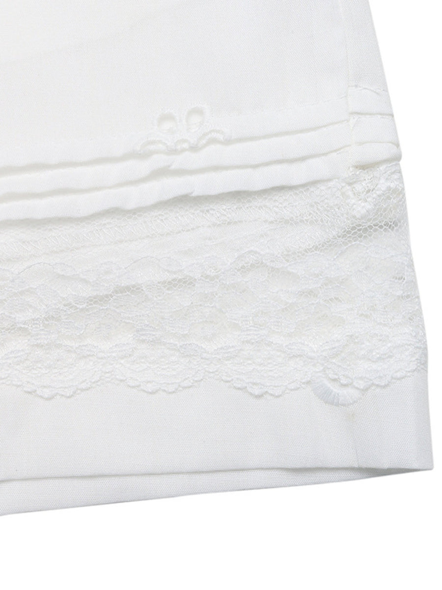 Close-up of a white textured fabric with lace trim on a white background