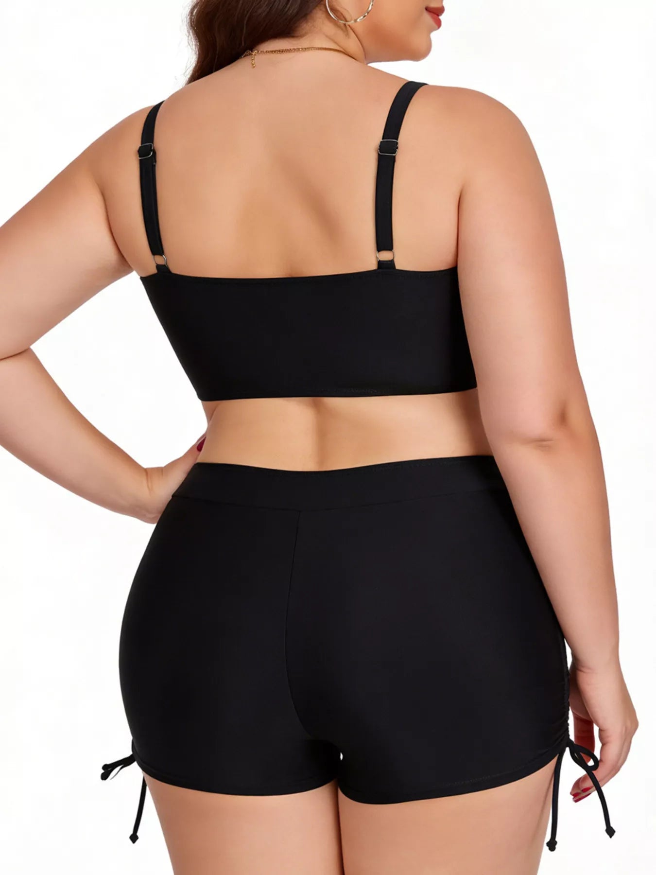 Person wearing a black bikini set on a white background