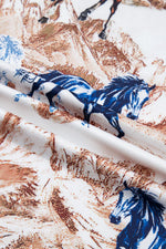 Close-up of fabric with blue and white horse pattern on a brown and beige background