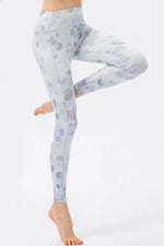 Light blue floral leggings worn by a person on a white background