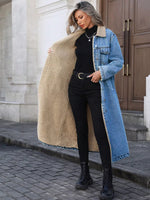 Woman wearing a long denim coat with a beige sherpa lining, standing on a street.