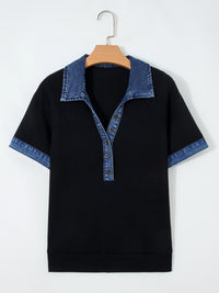 Black t-shirt with denim collar and cuffs on a wooden hanger against a white background
