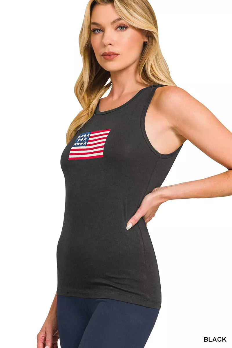 Woman wearing a black tank top with an American flag design on a white background