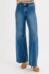 Blue jeans worn by a person on a white background