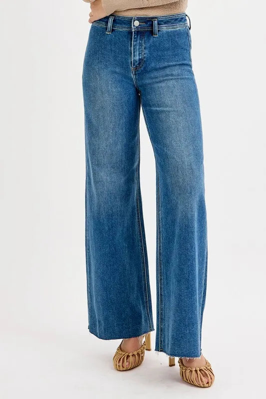 Blue jeans worn by a person on a white background