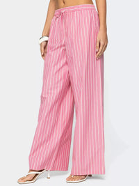 Pink striped pants worn by a person on a white background