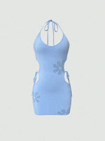 Light blue dress with floral cutouts on a light gray background