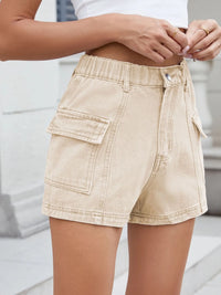 Beige cargo shorts worn by a person with a blurred background