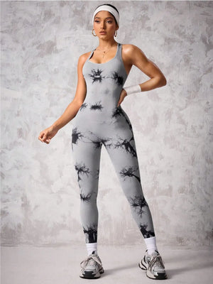 Woman wearing a gray and black patterned jumpsuit against a gray background