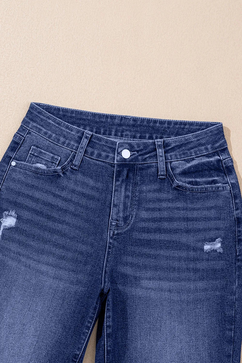 Close-up of blue jeans with a beige background
