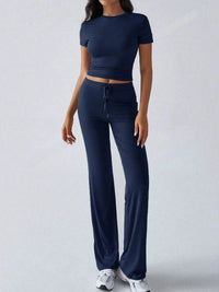 Person wearing a navy blue athletic outfit on a light gray background