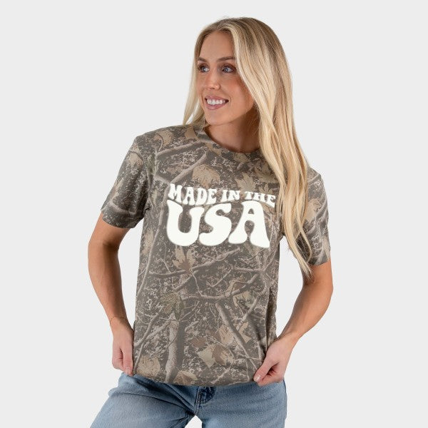 Woman wearing a camouflage t-shirt with 'Made in the USA' text on a white background