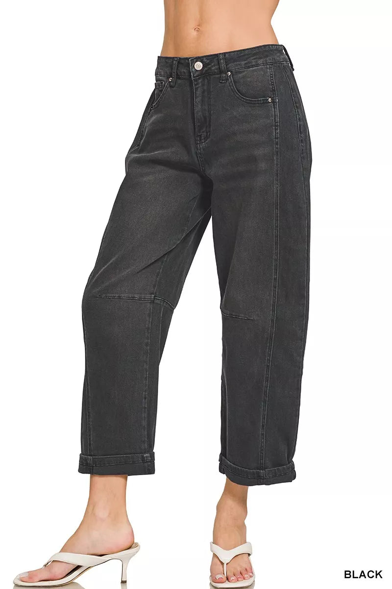 Black jeans worn by a person on a white background