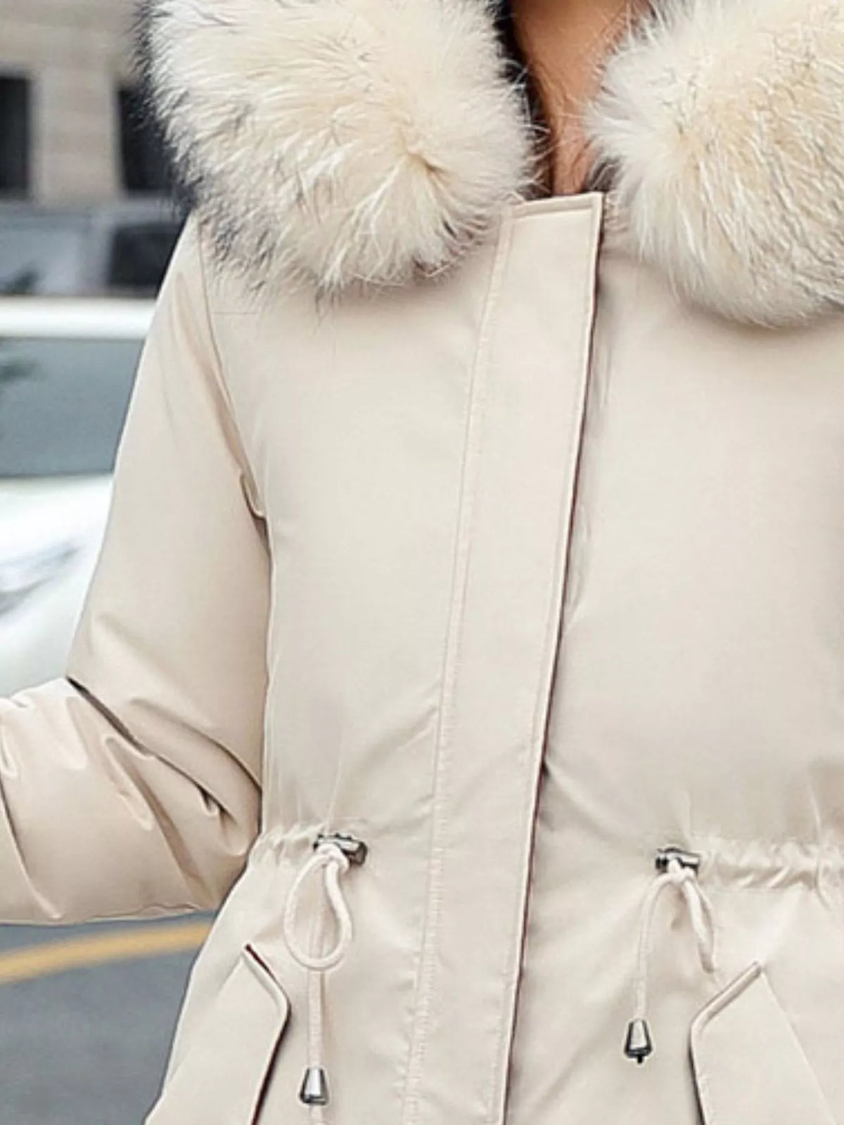 Zoom in view of the chest area of Women's Detachable Longline Hooded Parka with Faux Fur Trim and Drawstring Waist
