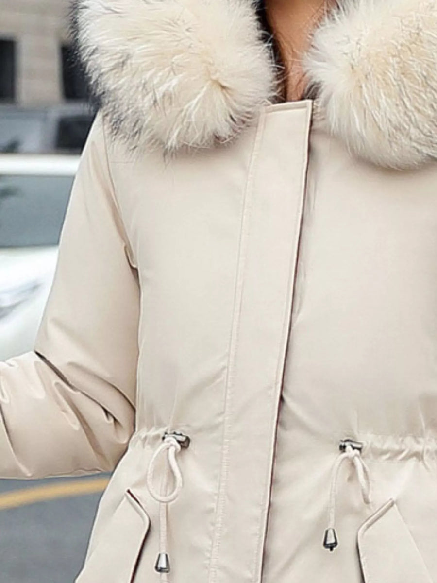 Zoom in view of the chest area of Women's Detachable Longline Hooded Parka with Faux Fur Trim and Drawstring Waist