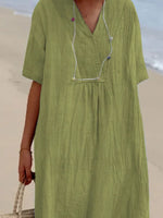 Green dress worn by a person on a beach
