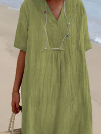 Green dress worn by a person on a beach