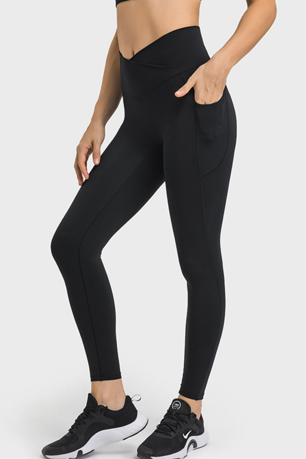 Person wearing black leggings on a white background