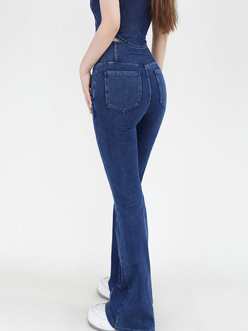 Person wearing blue jeans on a white background