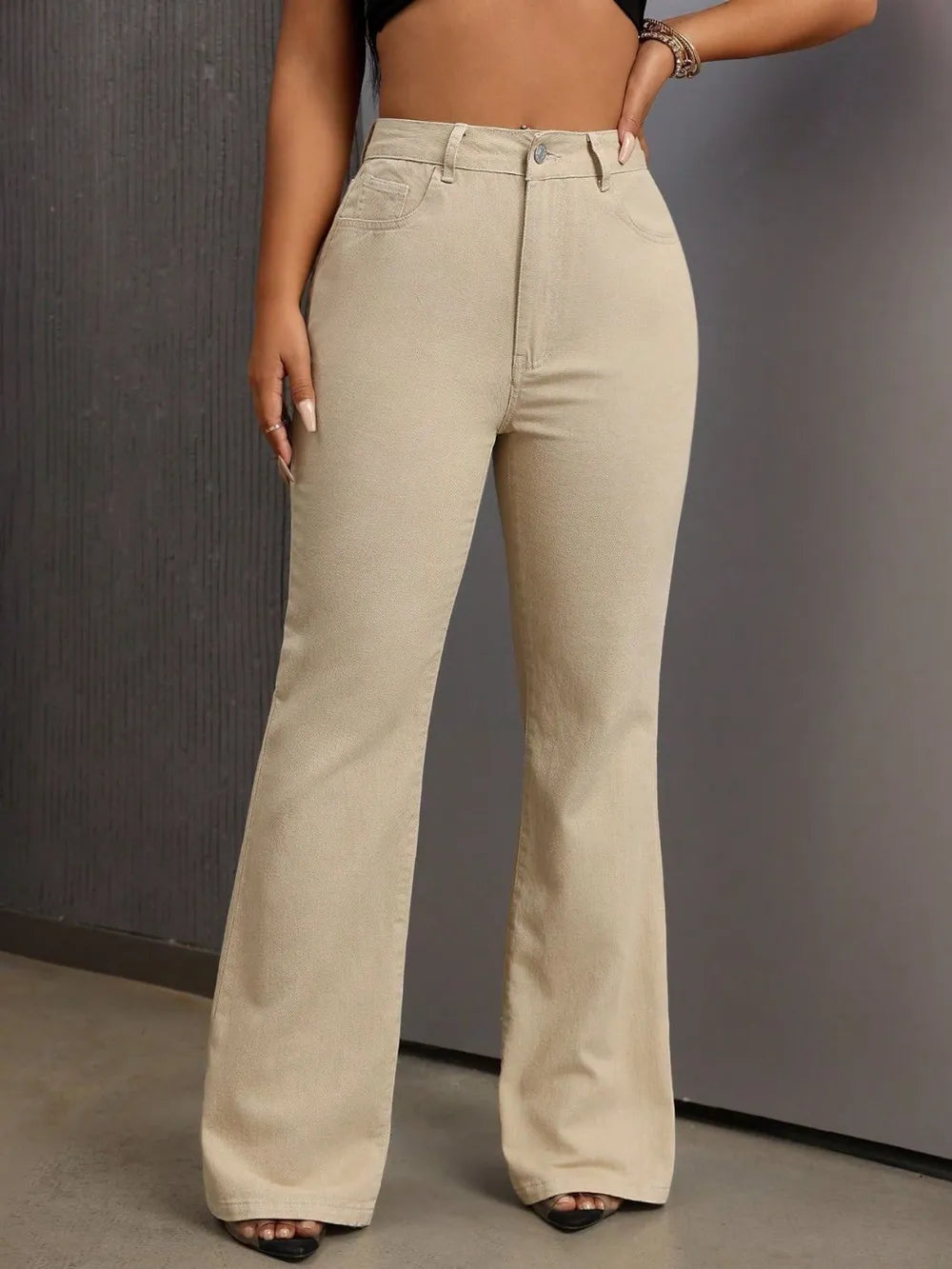 Beige wide-leg pants worn by a person against a gray background