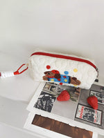 White pouch with a cartoon dog design on a white surface
