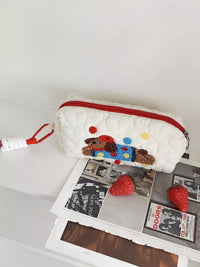 White pouch with a cartoon dog design on a white surface