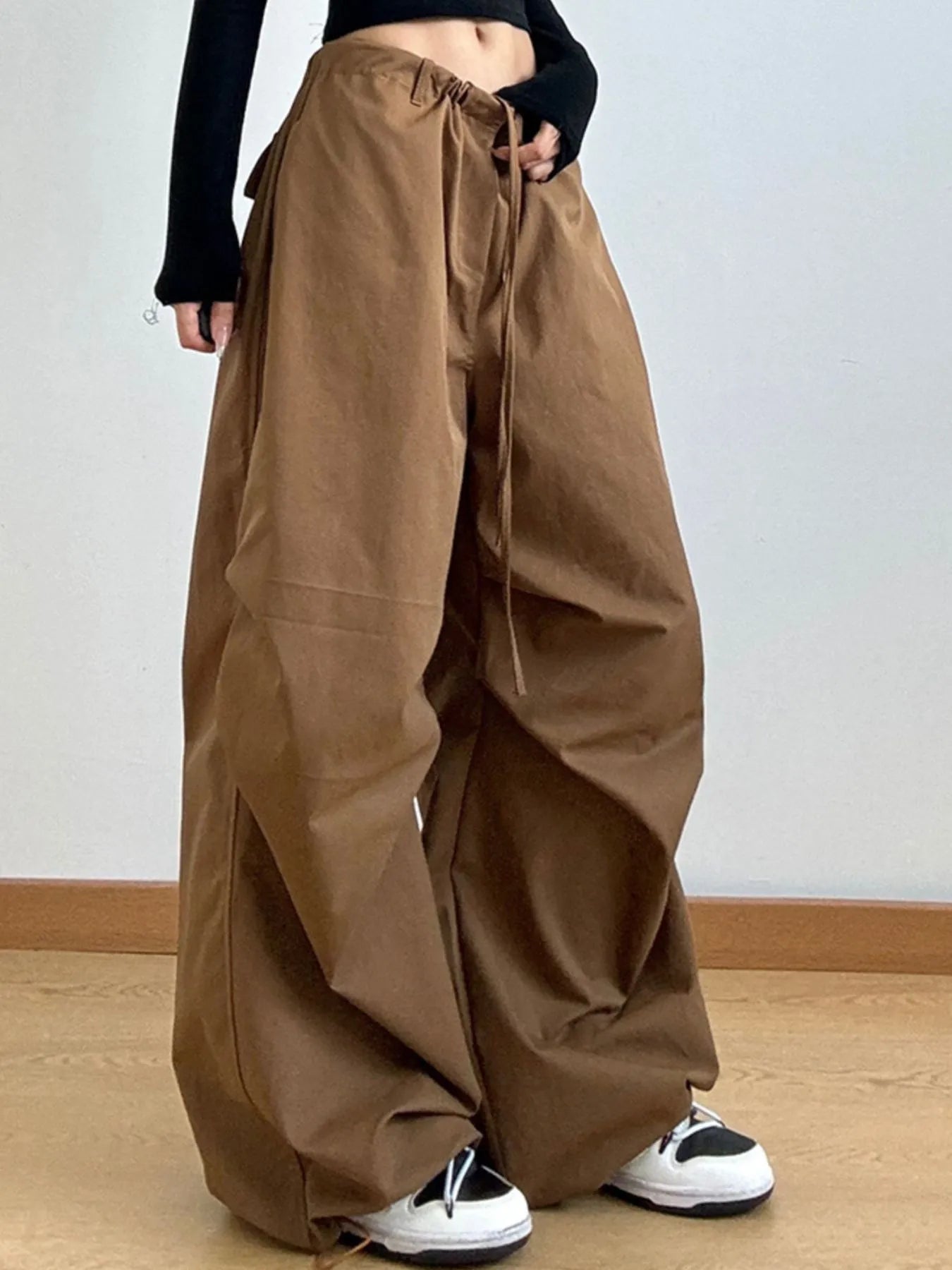 Brown wide-leg pants worn by a person on a plain background