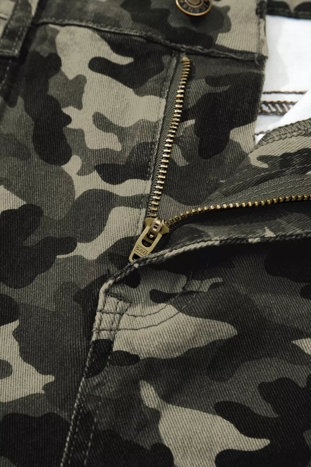 Close-up of a camouflage jacket with a zipper