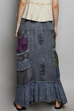 Long patchwork skirt with floral patterns on a plain background
