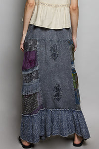Long patchwork skirt with floral patterns on a plain background