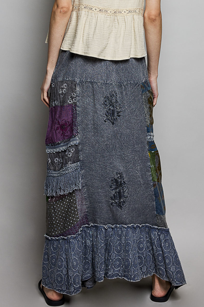 Long patchwork skirt with floral patterns on a plain background