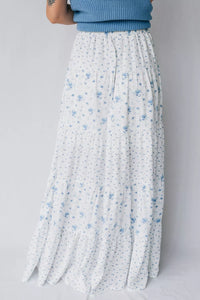 White floral skirt with blue flowers on a plain background