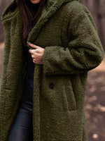 Person wearing a green teddy coat with a blurred background