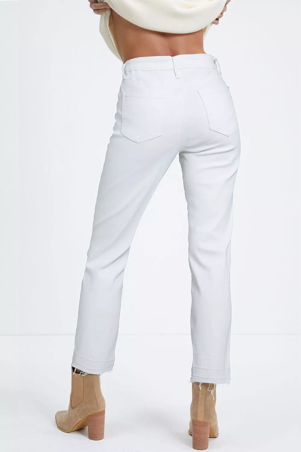 White pants worn by a person on a white background