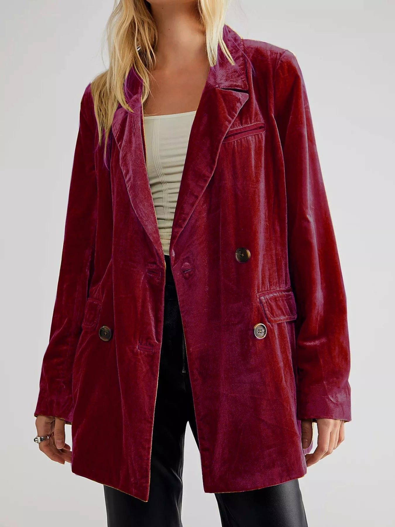 Maroon velvet coat worn by a person on a white background