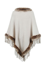 White poncho with brown fur trim and fringes on a white background