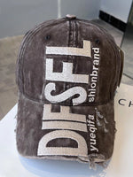 Brown cap with 'DIESEL' branding on a white surface