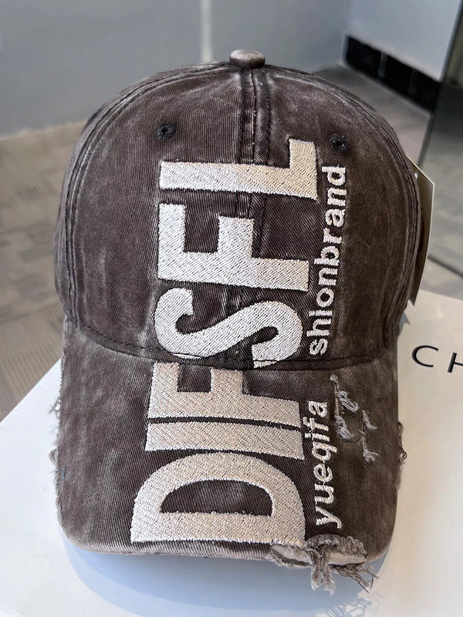 Brown cap with 'DIESEL' branding on a white surface