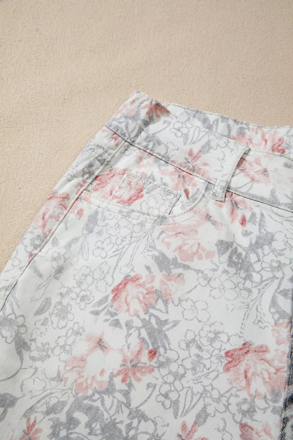 Floral patterned shorts on a beige background