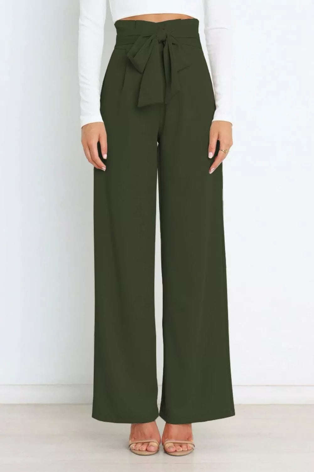 Green wide-leg pants with a tie waist worn by a person on a white background