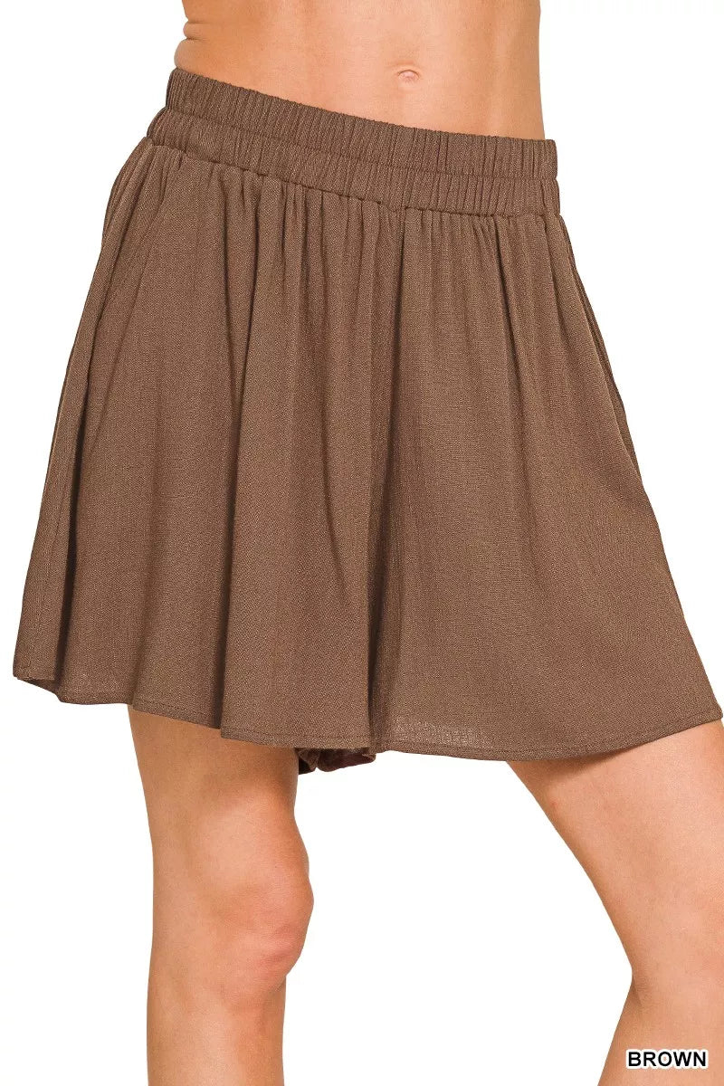 Brown skirt worn by a person on a white background