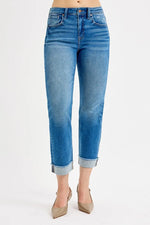 Blue jeans with rolled-up cuffs on a white background