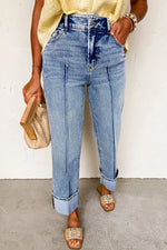 Person wearing blue jeans with a plain background