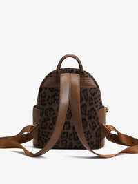 Leopard print backpack with brown straps on a white background