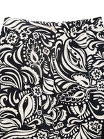 Black and white patterned fabric with floral and paisley designs.