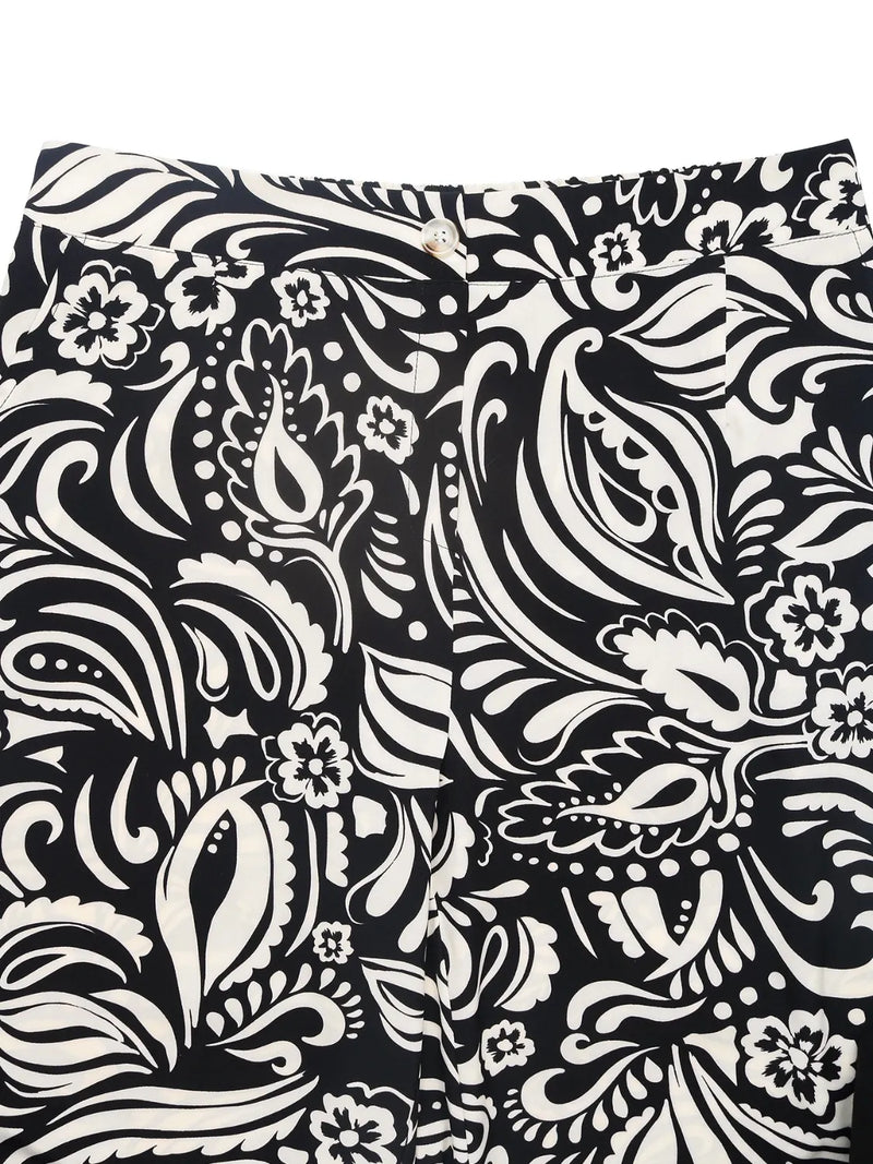 Black and white patterned fabric with floral and paisley designs.