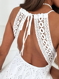White crochet halter top worn by a person on a white background