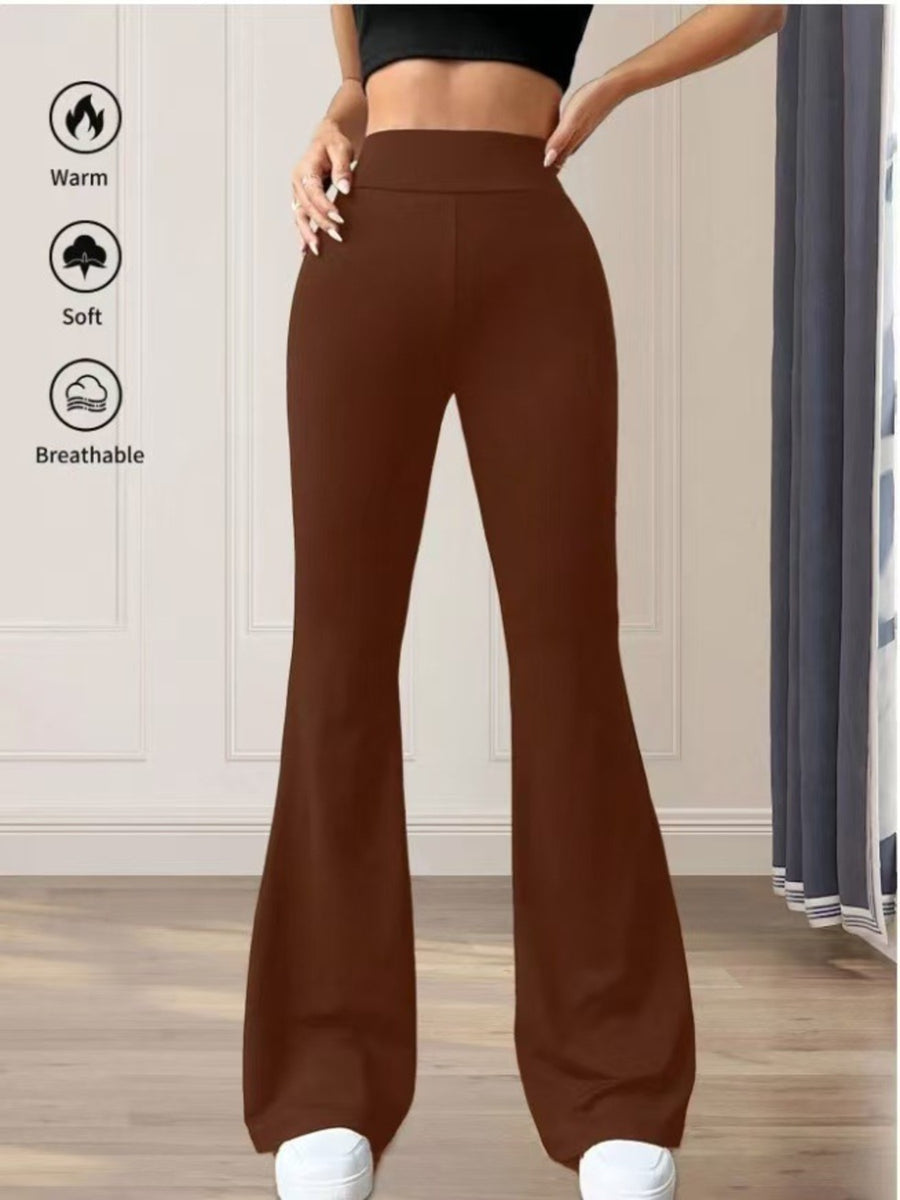 Brown flared pants worn by a person with text icons indicating warmth, softness, and breathability on a neutral background.